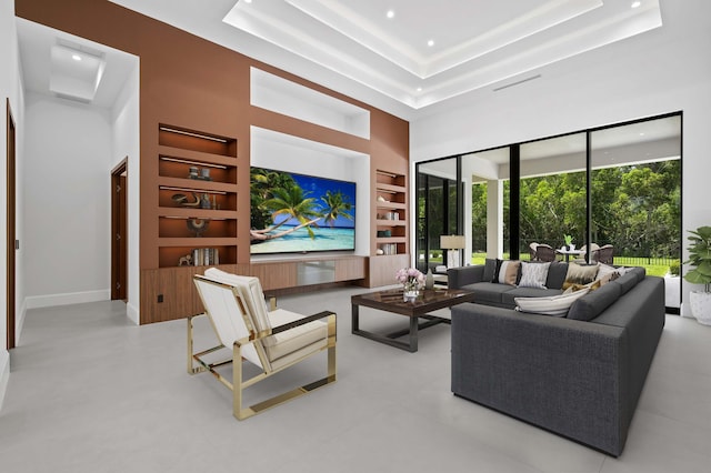 living room with a towering ceiling and built in features