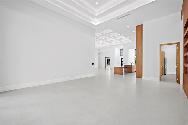 spare room with coffered ceiling and sink