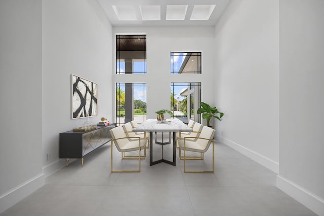 dining space featuring a towering ceiling