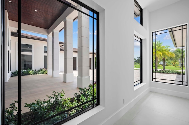 unfurnished sunroom featuring a wealth of natural light and wood ceiling