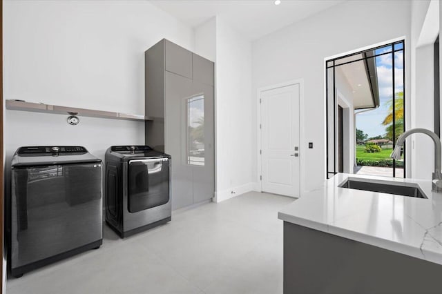 laundry room featuring sink and washer and clothes dryer