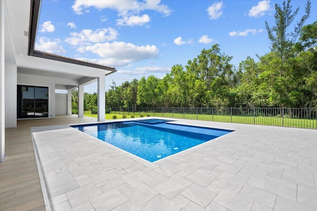 view of pool with a lawn and a patio