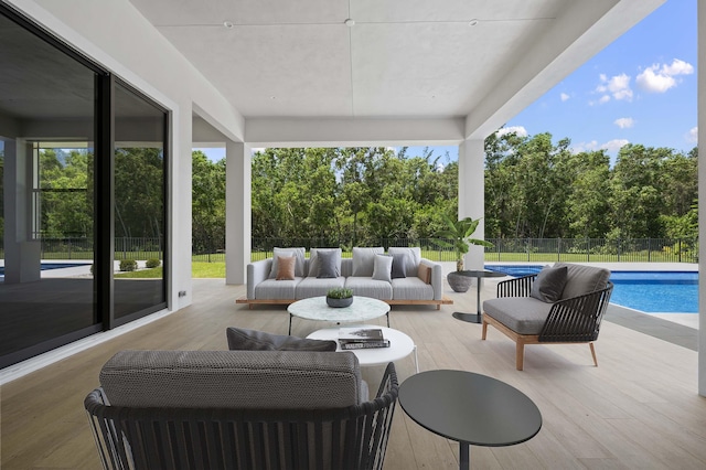 view of patio / terrace with a fenced in pool and an outdoor living space