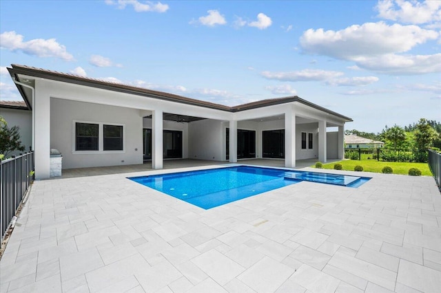 view of swimming pool with a patio and ceiling fan