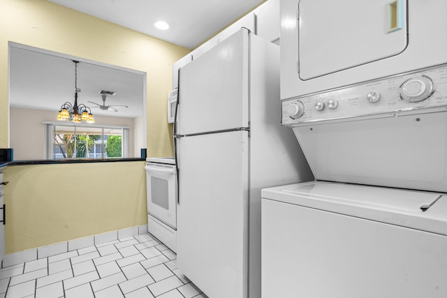 laundry room featuring light tile patterned flooring, stacked washer and dryer, and an inviting chandelier