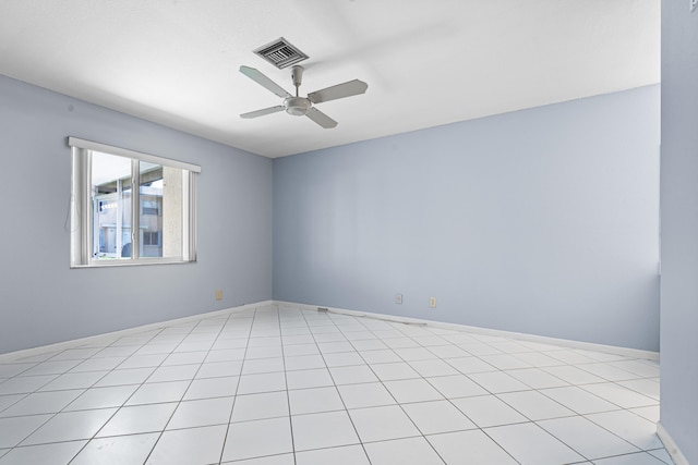 tiled empty room featuring ceiling fan