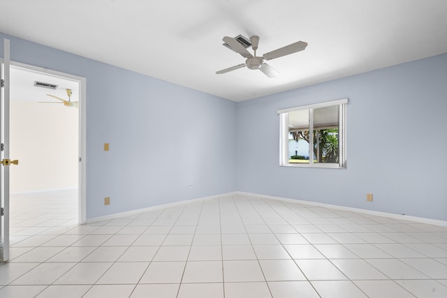 spare room with ceiling fan and light tile patterned floors