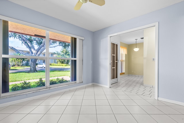 tiled empty room with ceiling fan