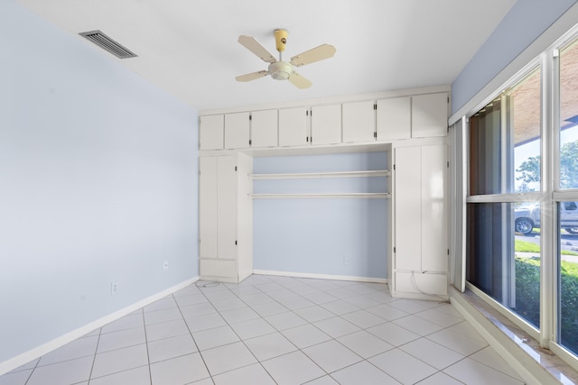 unfurnished bedroom with ceiling fan, a closet, and light tile patterned floors