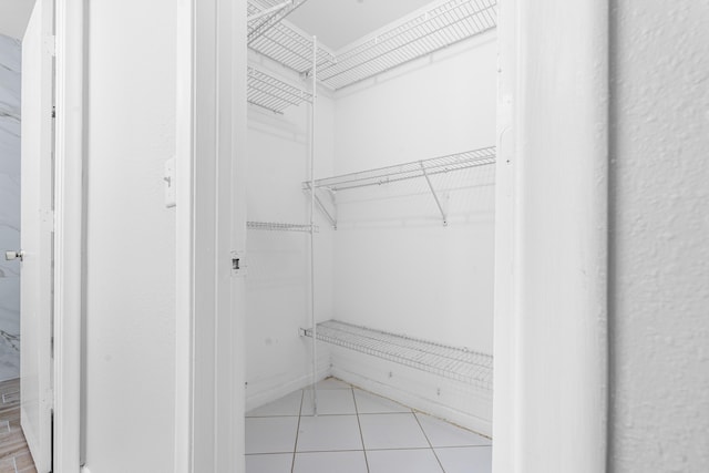 spacious closet with light tile patterned floors