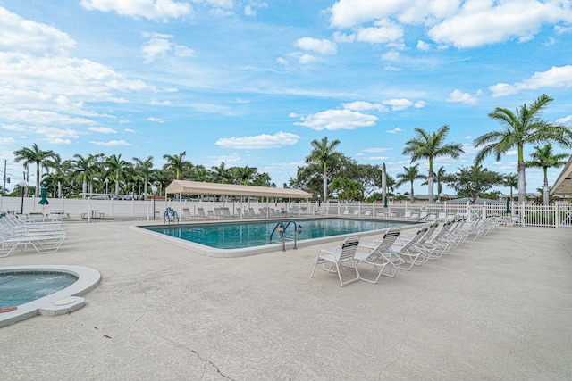 view of swimming pool with a jacuzzi and a patio area