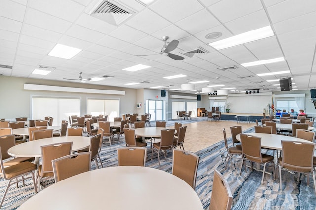 dining area featuring a paneled ceiling and ceiling fan