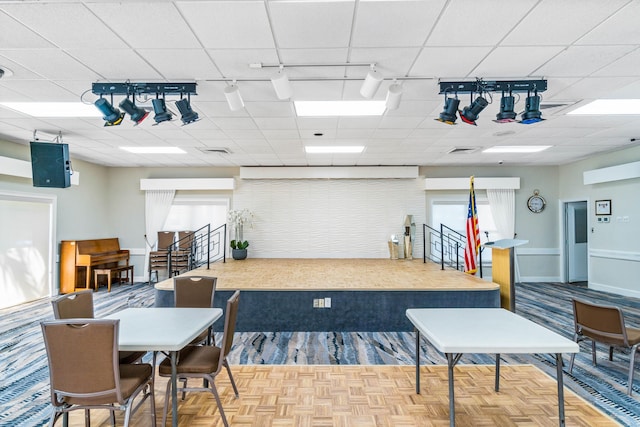 misc room featuring parquet floors and track lighting