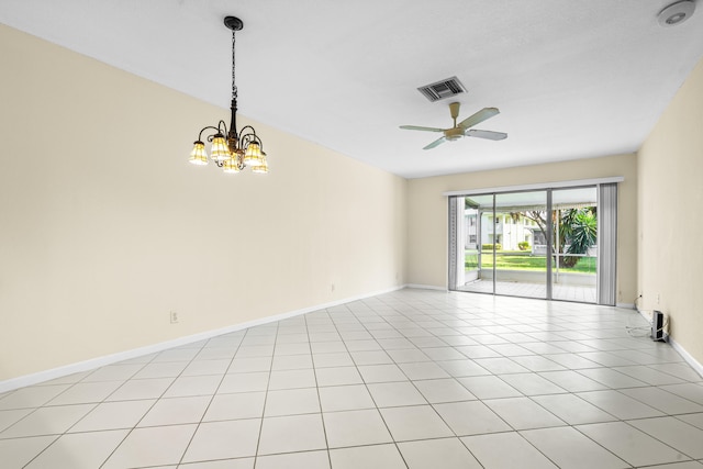 empty room with light tile patterned floors and ceiling fan with notable chandelier