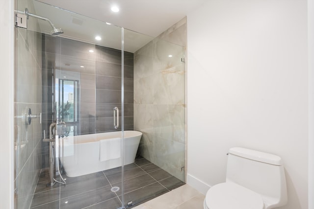 bathroom featuring tile patterned floors, shower with separate bathtub, and toilet