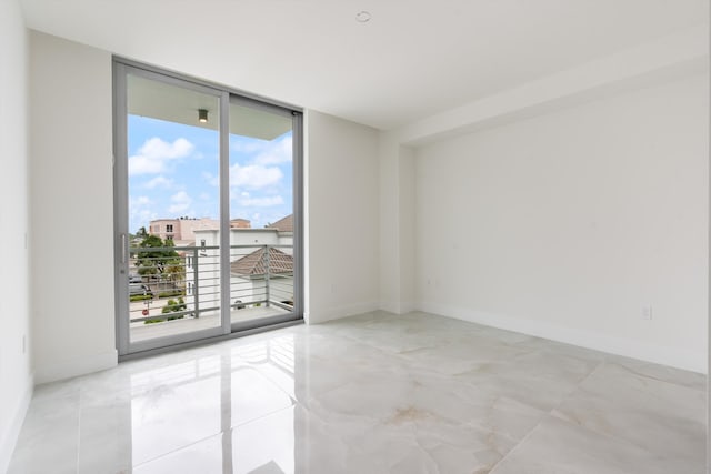 unfurnished room with expansive windows