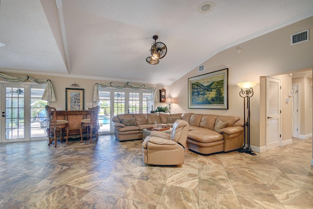 living room with ornamental molding, indoor bar, french doors, and lofted ceiling