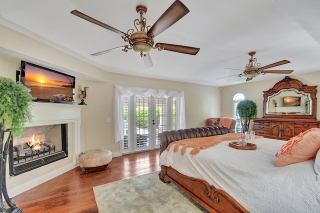 bedroom featuring access to outside, ceiling fan, and wood-type flooring