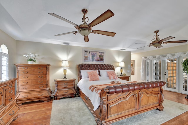 bedroom featuring access to outside, ceiling fan, and light hardwood / wood-style floors