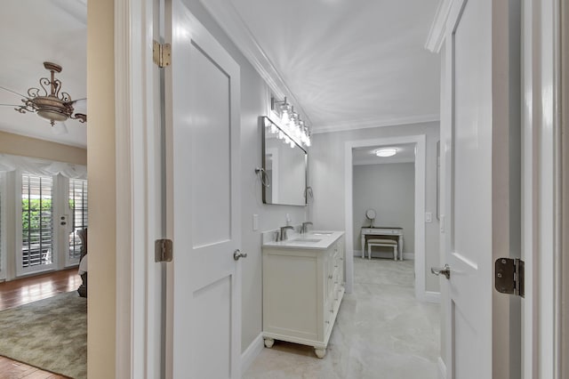 bathroom featuring crown molding, hardwood / wood-style floors, and vanity