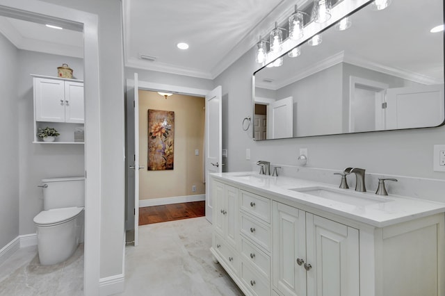 bathroom featuring hardwood / wood-style flooring, vanity, toilet, and crown molding