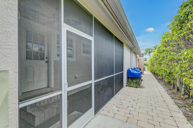 view of side of property featuring a sunroom