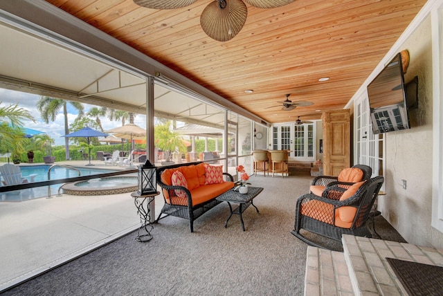 sunroom / solarium featuring ceiling fan, a pool, and wood ceiling