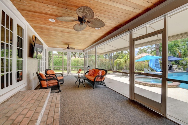 sunroom / solarium featuring ceiling fan and wooden ceiling