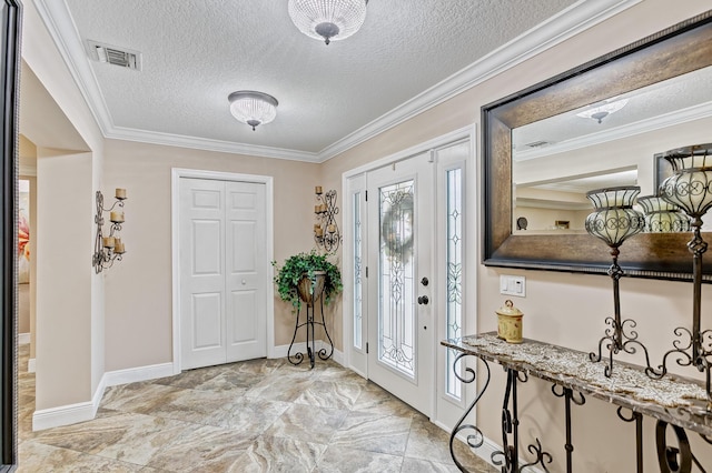 entryway with a textured ceiling and crown molding