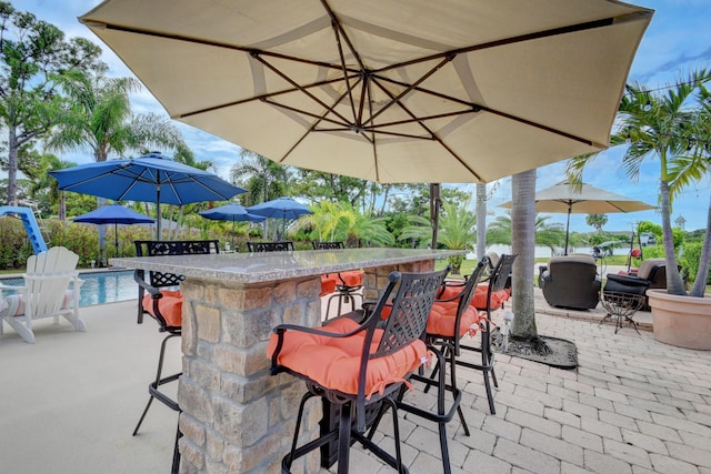 view of patio / terrace featuring an outdoor bar