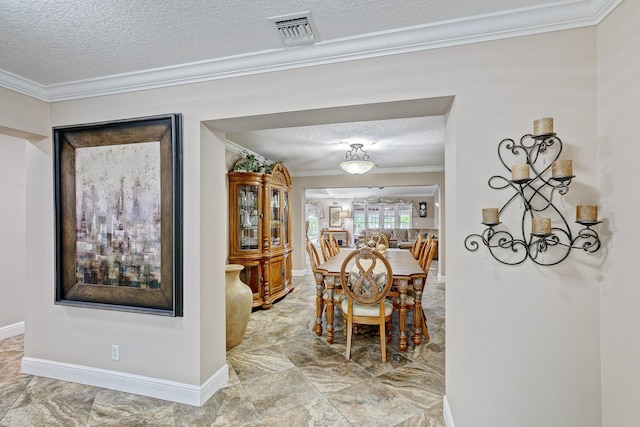 dining space featuring crown molding and a textured ceiling