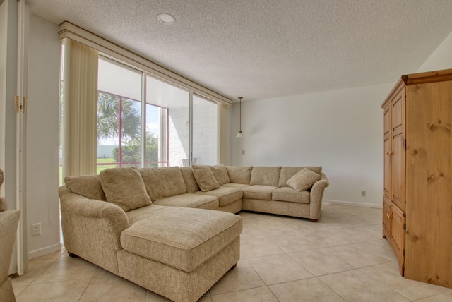 living room with light tile patterned floors and a textured ceiling