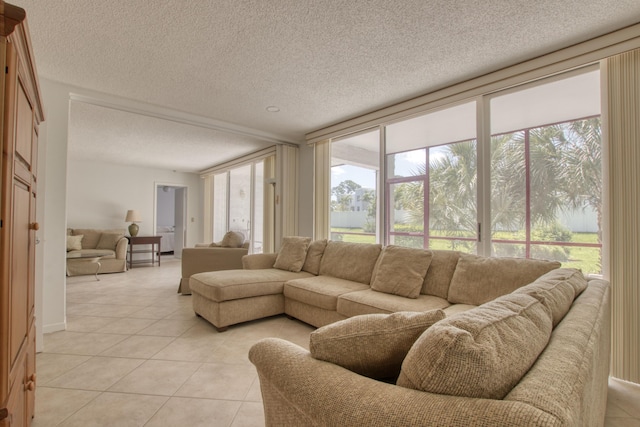 tiled living room with a textured ceiling and a wall of windows