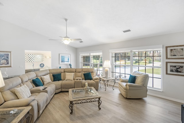 living room featuring ceiling fan, light hardwood / wood-style floors, and vaulted ceiling