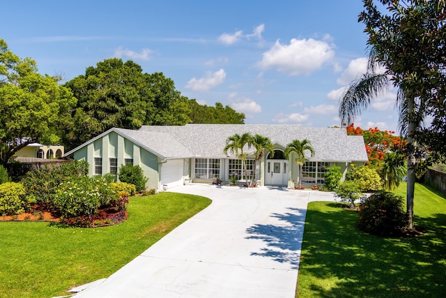 ranch-style home with a garage and a front yard