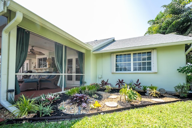 view of home's exterior with a sunroom