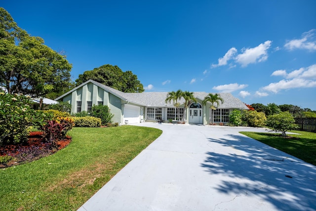 ranch-style home with a front lawn and a garage