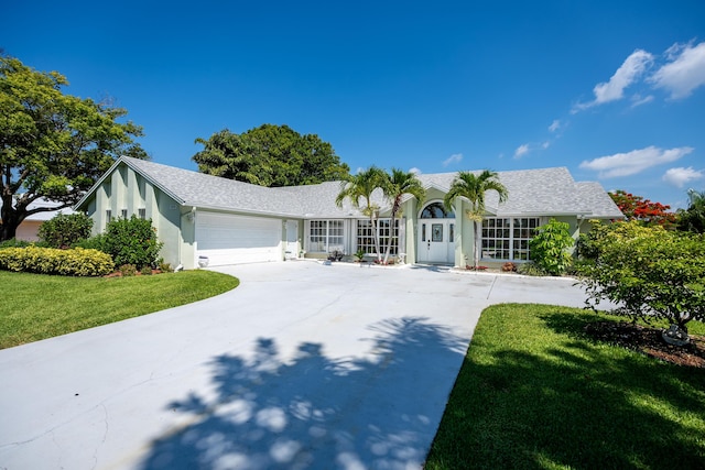 ranch-style home featuring a front yard and a garage