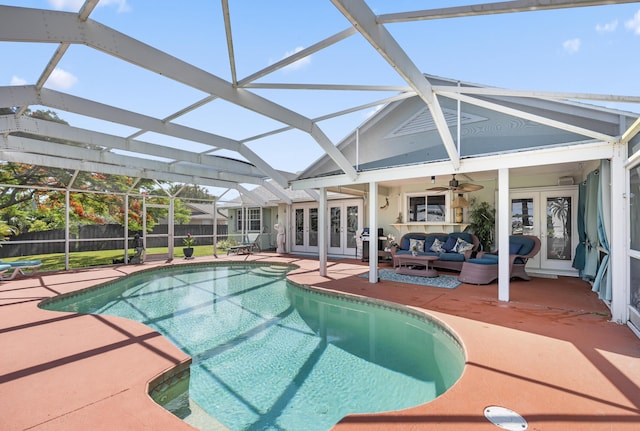 view of pool with outdoor lounge area, french doors, and a patio