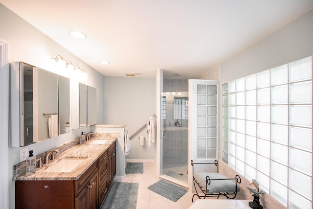 bathroom with tile patterned flooring, vanity, a shower with shower door, and toilet