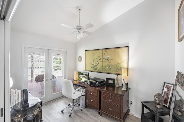 office featuring ceiling fan, vaulted ceiling, light wood-type flooring, and french doors