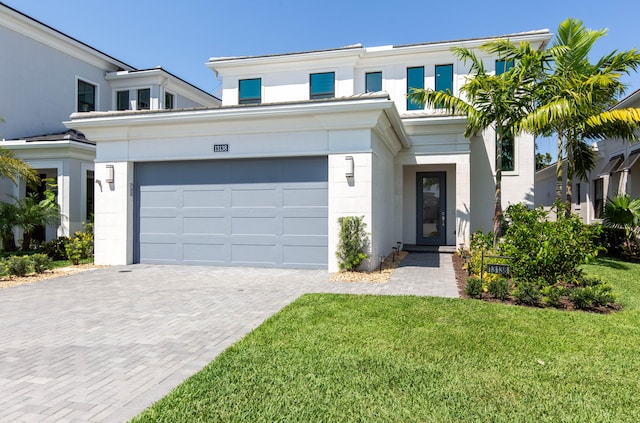 view of front of house featuring a garage and a front yard