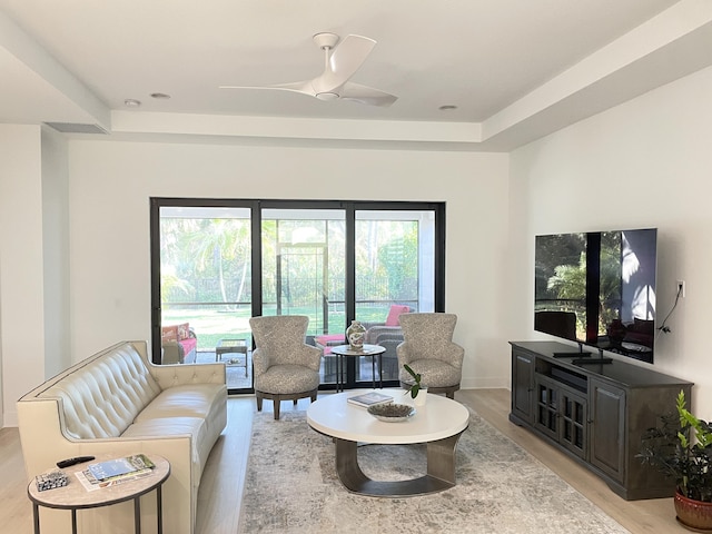 living room with ceiling fan and light wood-type flooring