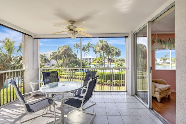 sunroom / solarium featuring plenty of natural light and ceiling fan