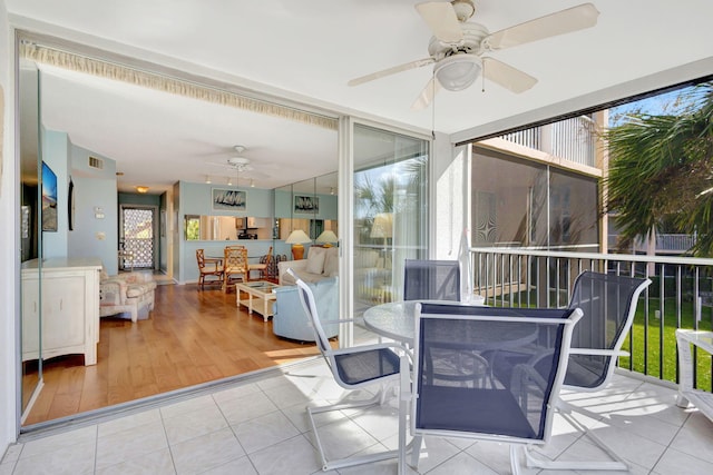 sunroom / solarium with ceiling fan