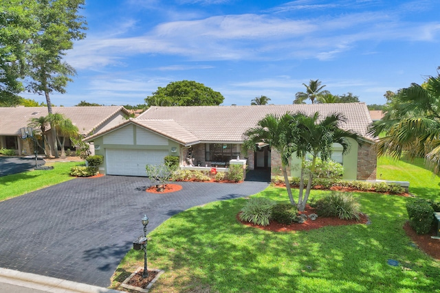 ranch-style home featuring a garage and a front lawn