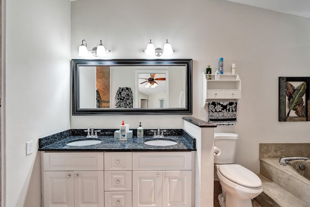 bathroom featuring vanity, a bathing tub, vaulted ceiling, ceiling fan, and toilet