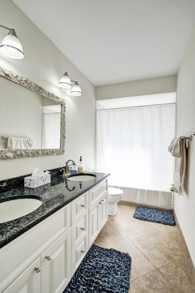 bathroom featuring tile patterned floors, plenty of natural light, toilet, and vanity