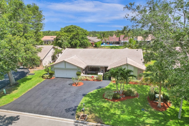 view of front of house featuring a garage and a front lawn