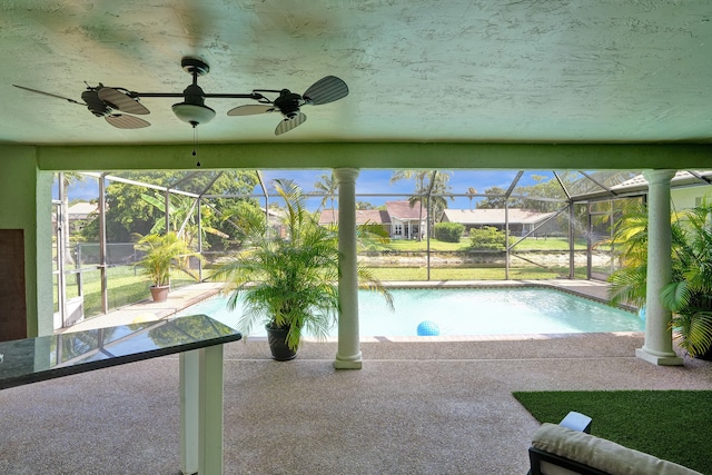 view of swimming pool featuring ceiling fan and a patio